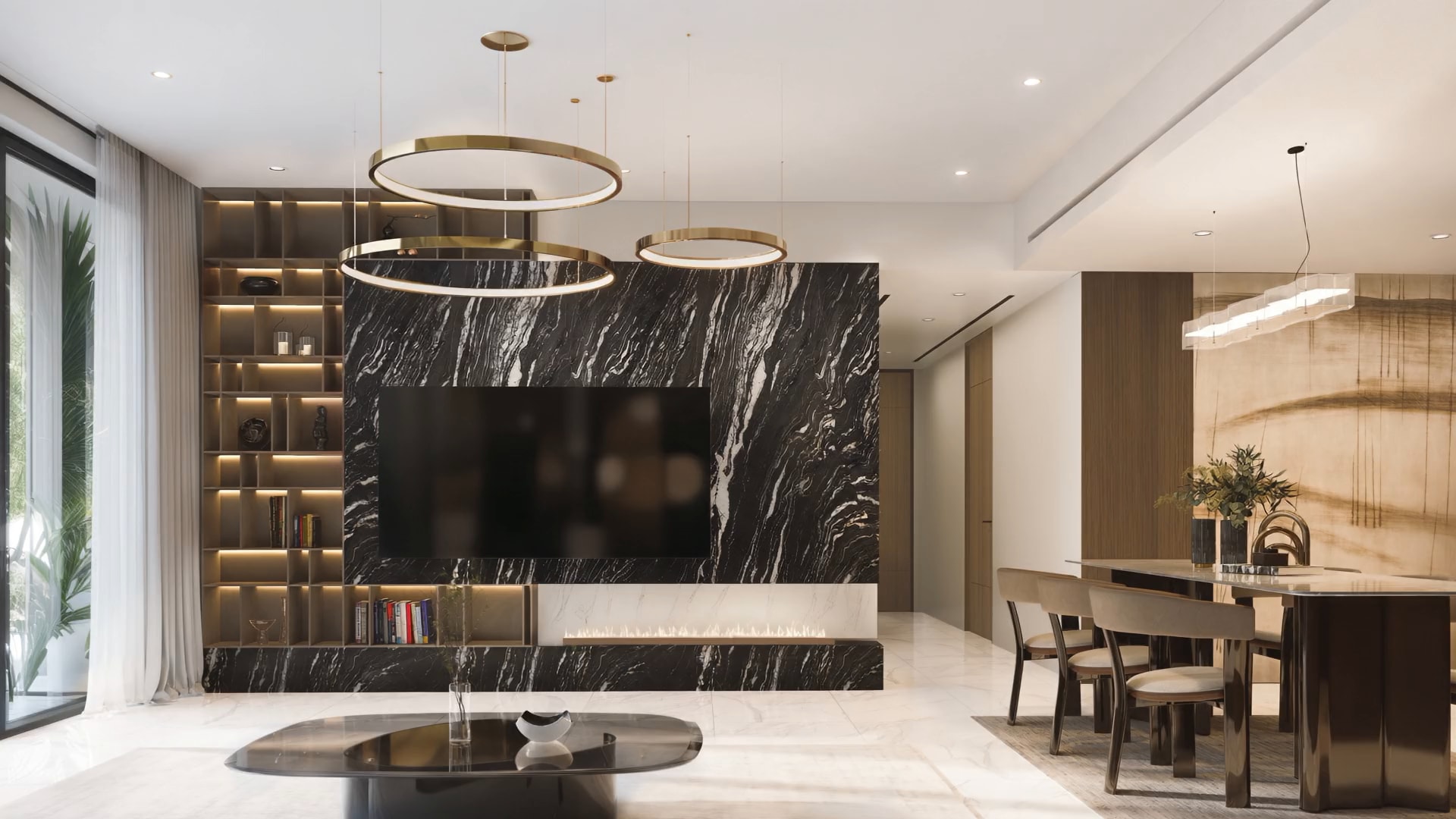 Living room with a black marble TV wall, brass ring pendants and a dining table